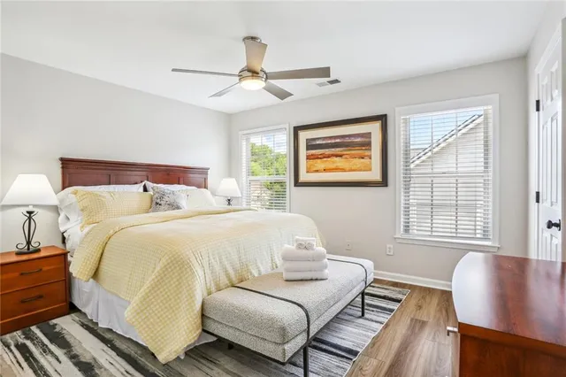 a bedroom with a bed and wooden floor