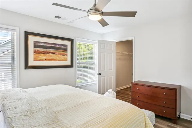 a bedroom with a bed and a painting on the wall