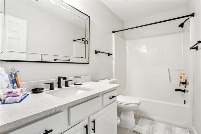 a bathroom with a sink a toilet and a bathtub