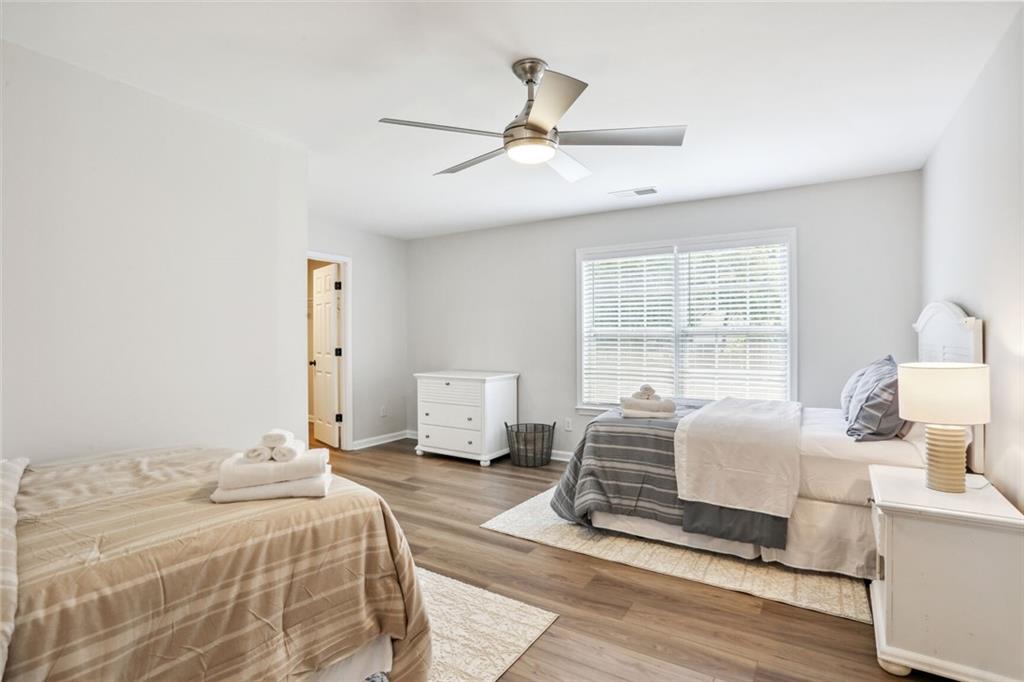 5161 Madison Green Drive Southwest Mableton, GA 30126 - Photo 37 of 40 a bedroom with a bed and wooden floor