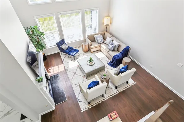 a living room with furniture and a wooden floor