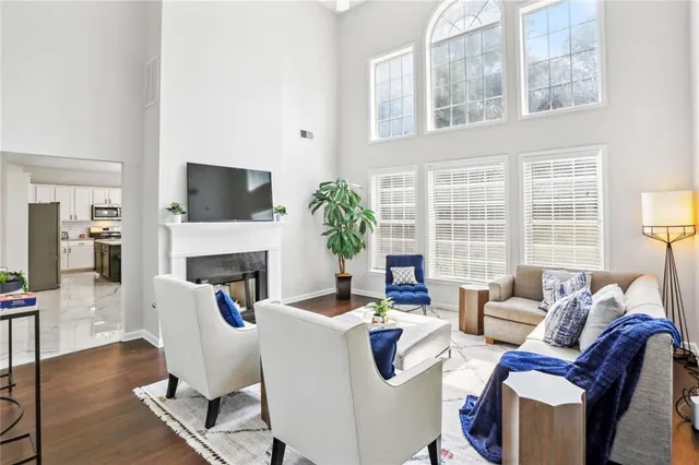 a living room with furniture a fireplace and a flat screen tv