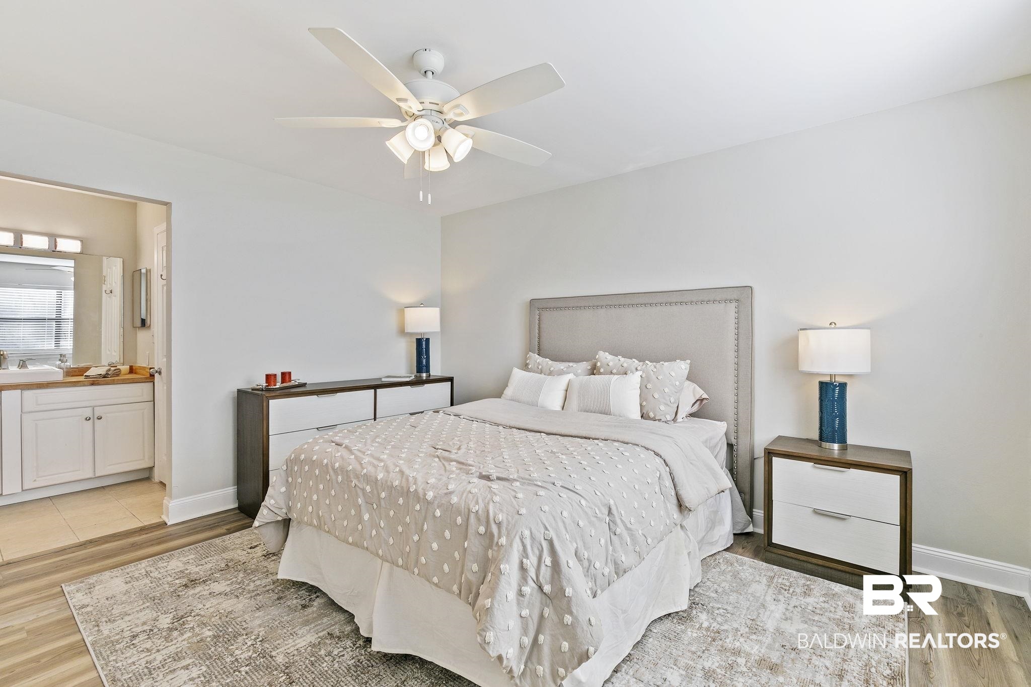 110 5th Street, Unit C103 Daphne, AL 36526 - Photo 30 of 46 Bedroom with sink, connected bathroom, light wood-type flooring, and ceiling fan