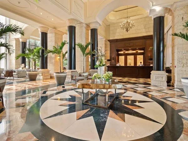 a living room with large couches table and chairs