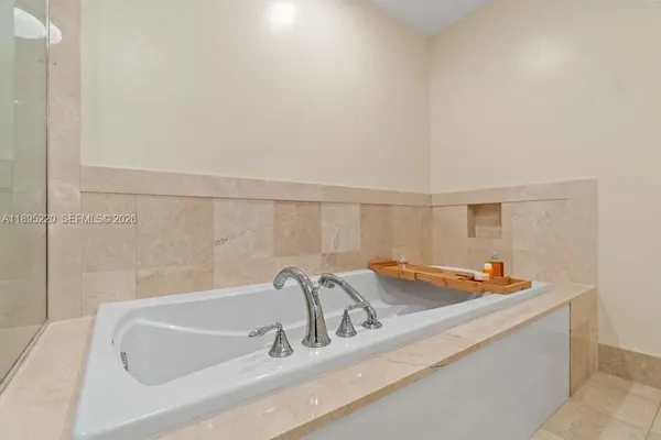 a large bedroom with a large bed and a large mirror