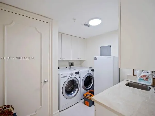 a living room with fireplace furniture and a large window