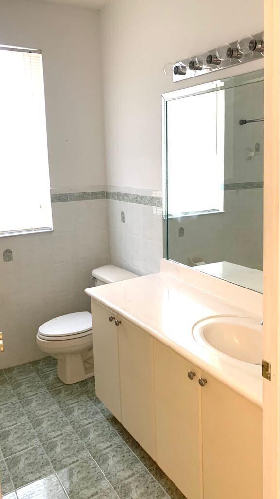 15809 Southwest 60th Terrace Miami, FL 33193 - Photo 11 of 20 a bathroom with a toilet sink and mirror
