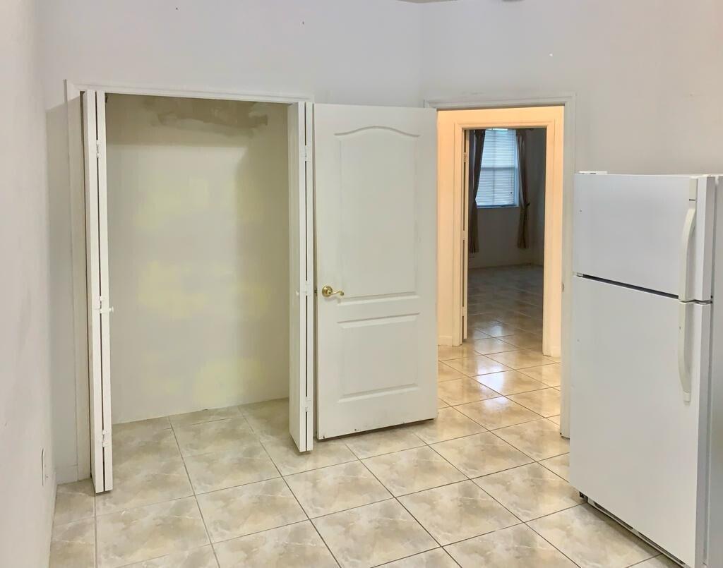 15809 Southwest 60th Terrace Miami, FL 33193 - Photo 14 of 20 a view of a hallway with a refrigerator and a table