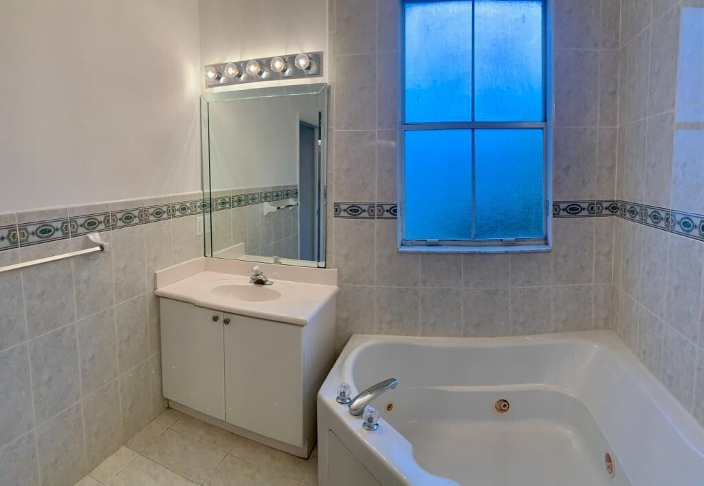 15809 Southwest 60th Terrace Miami, FL 33193 - Photo 17 of 20 a bathroom with a bathtub and shower