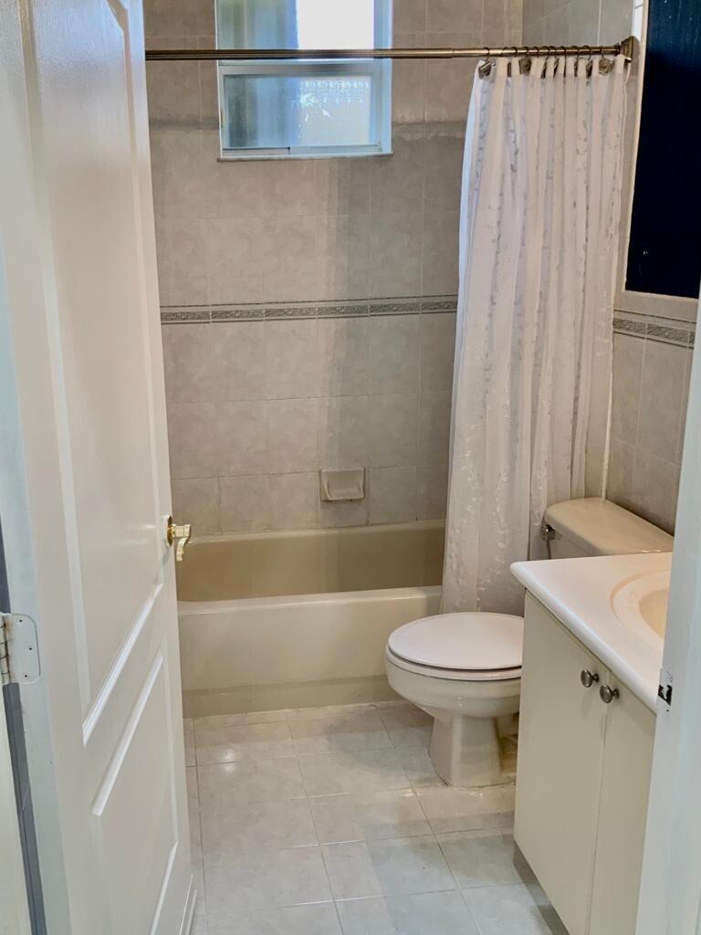 15809 Southwest 60th Terrace Miami, FL 33193 - Photo 8 of 20 a white toilet sitting next to a bath tub