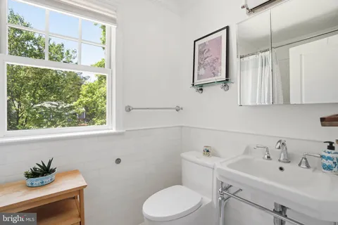 a bedroom with a bed lamps and window