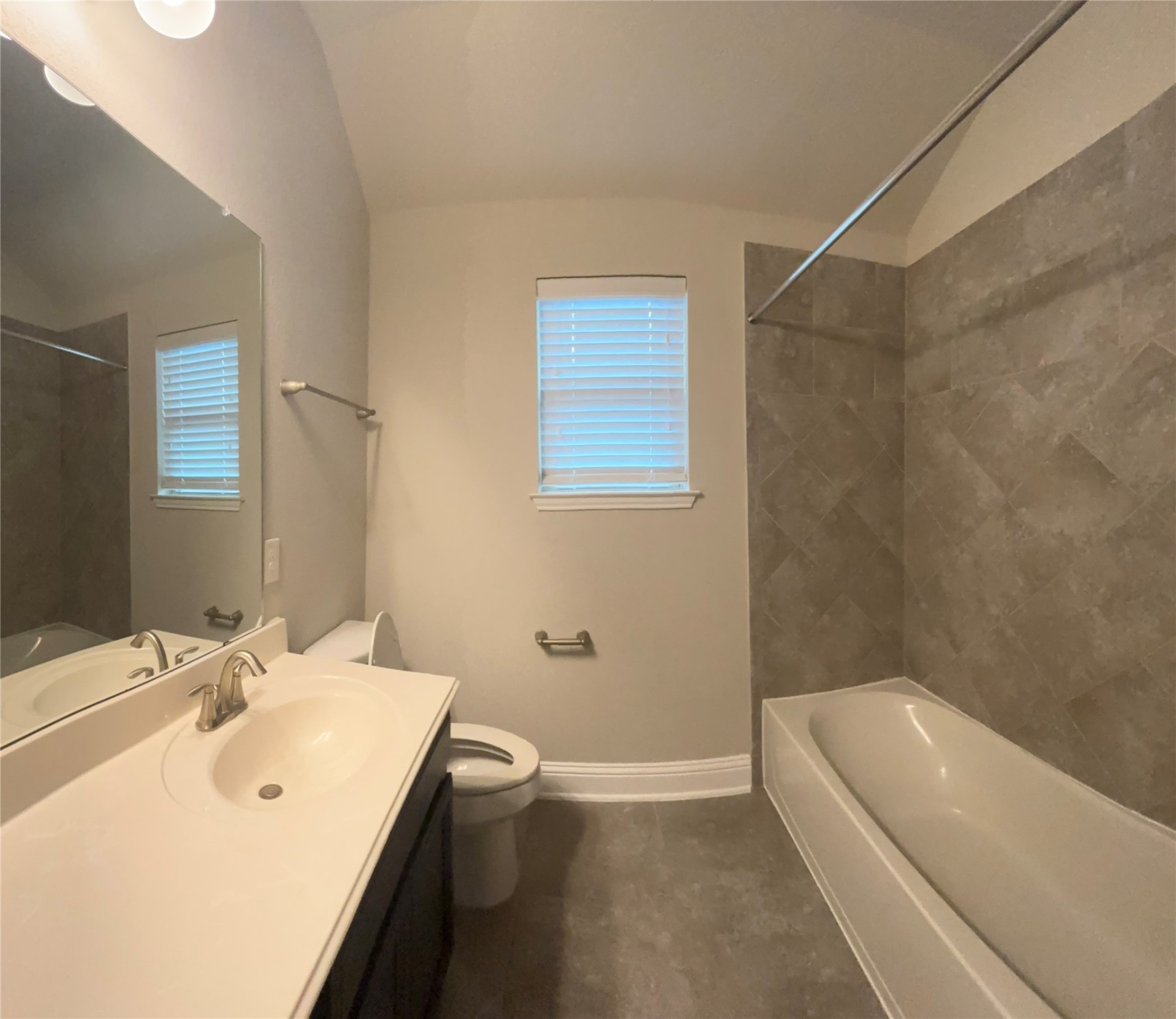 14915 Gyrfalcon Fork Cypress, TX 77429 - Photo 19 of 24 Luxurious upstairs bathroom featuring elegant tilework, a spacious tub, and modern fixtures for a serene retreat.