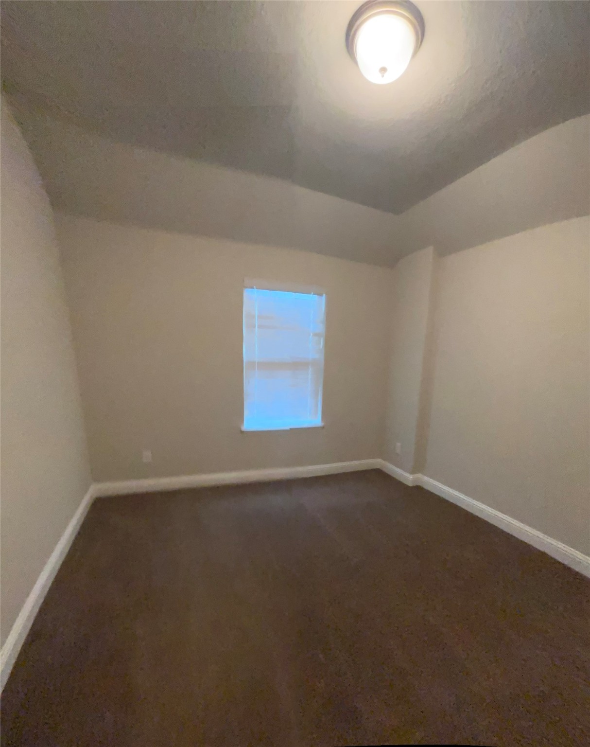14915 Gyrfalcon Fork Cypress, TX 77429 - Photo 22 of 24 Cozy fourth bedroom with soft lighting and a window for natural light, perfect for guests or a home office.
