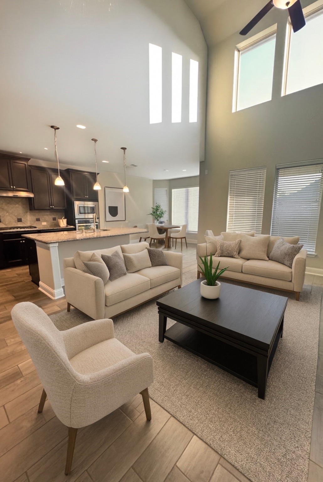 14915 Gyrfalcon Fork Cypress, TX 77429 - Photo 5 of 24 Expansive living room with soaring ceilings, abundant natural light from large windows, and sleek tile flooring, perfect for comfortable living and entertaining.Virtually staged