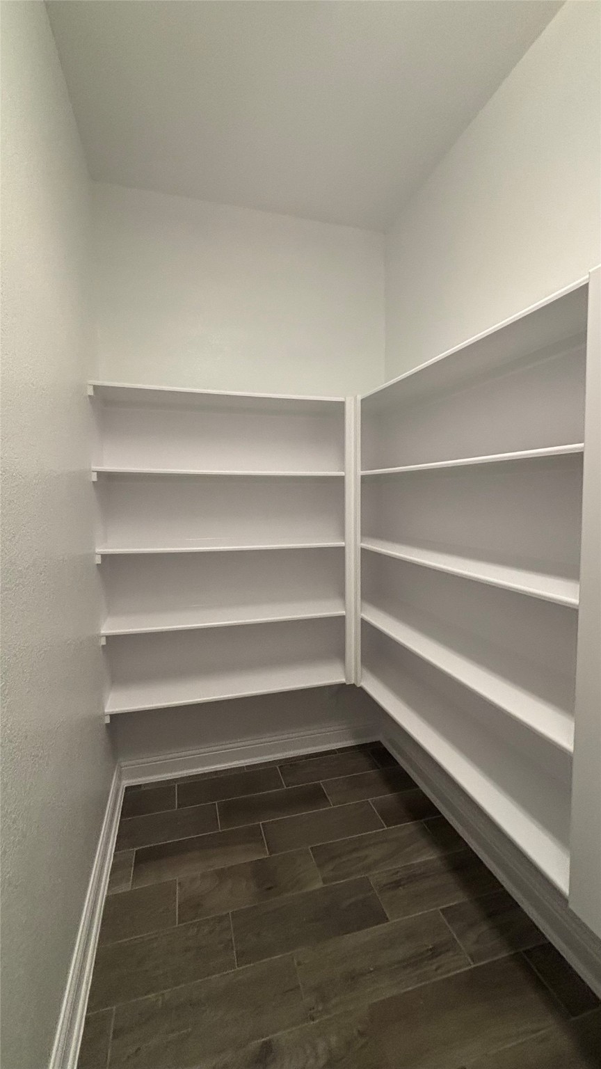 14915 Gyrfalcon Fork Cypress, TX 77429 - Photo 6 of 24 Spacious walk-in pantry with ample shelving for all your kitchen essentials.