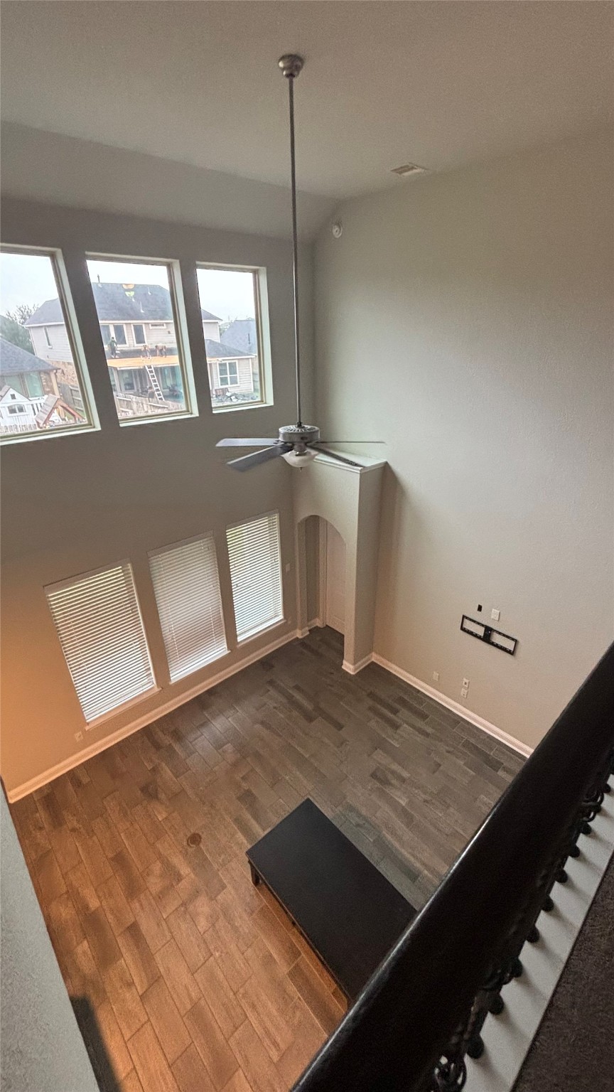 14915 Gyrfalcon Fork Cypress, TX 77429 - Photo 7 of 24 Spectacular two-story living room with expansive windows and elegant flooring, perfect for natural light and a spacious feel.