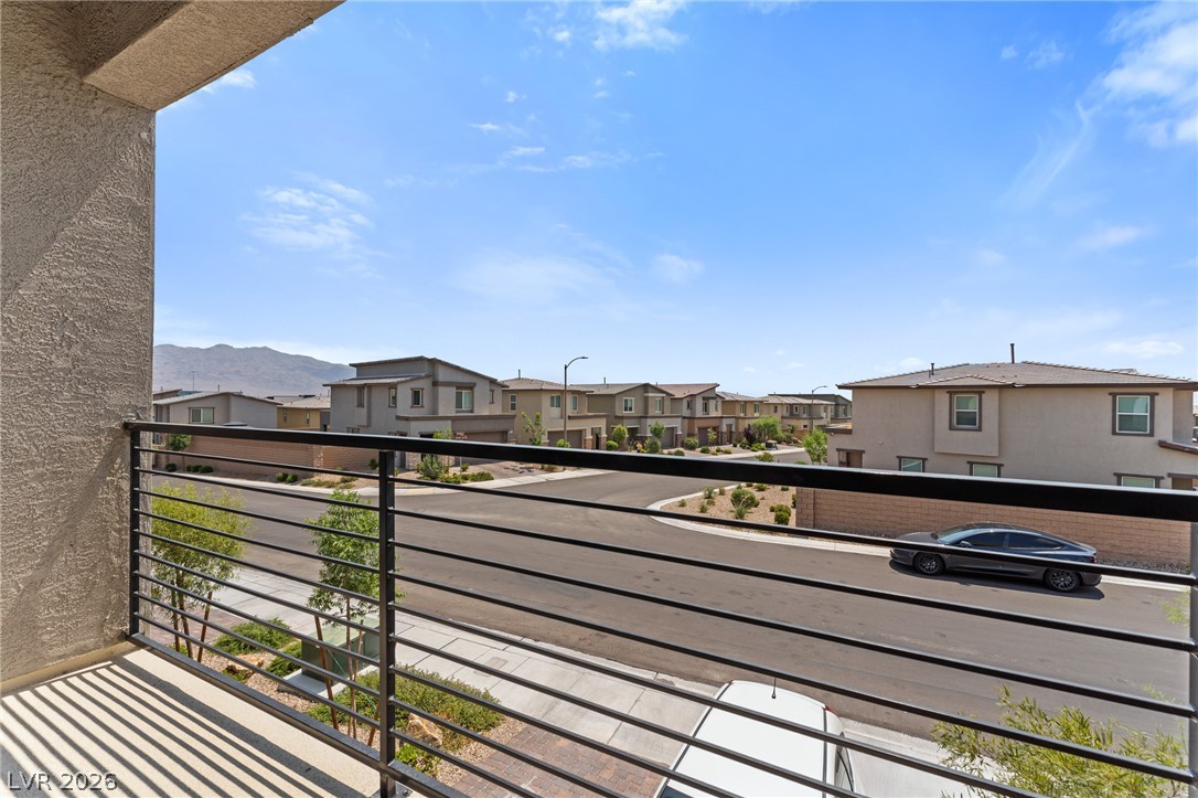 8879 Roadrunner Ravine Street Las Vegas, NV 89166 - Photo 19 of 39 Perched on a balcony, this home offers refreshing views of the neighborhood and distant mountains.