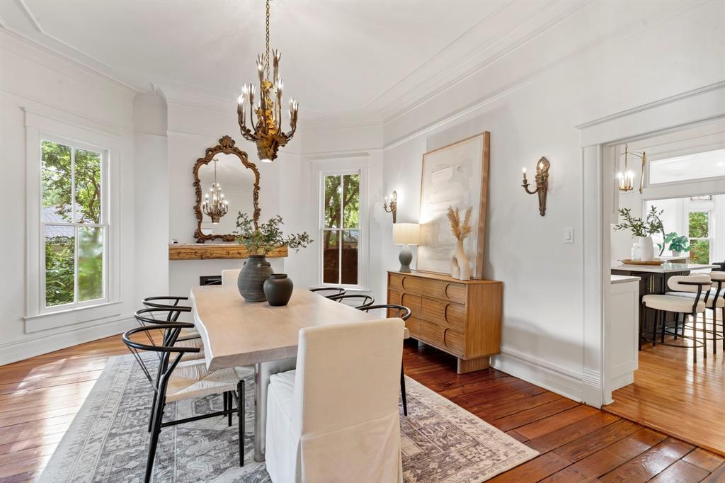 1502 West Virginia Street McKinney, TX 75069 - Photo 10 of 40 a dining room with wooden floor a chandelier a glass table and chairs