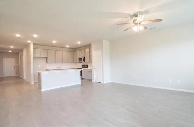 a view of a kitchen with a sink and a refrigerator