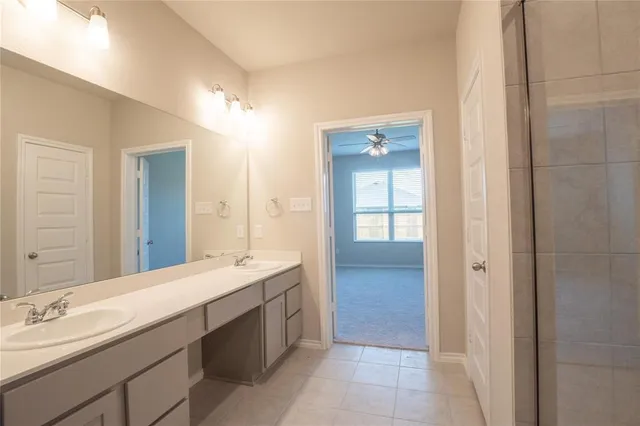 a bathroom with a double vanity sink and mirror