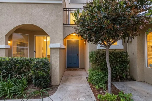 a front view of a house with yard and parking