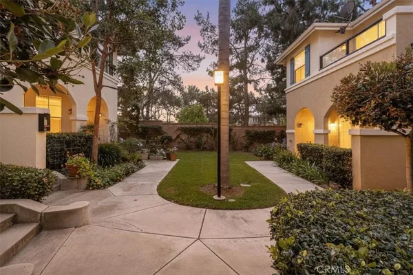 a bedroom with a bed a mirror and night stand