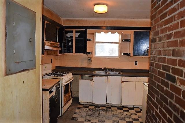 623 West Griffith Avenue Crestview, FL 32536 - Photo 8 of 11 a kitchen with stainless steel appliances a stove a sink and a microwave