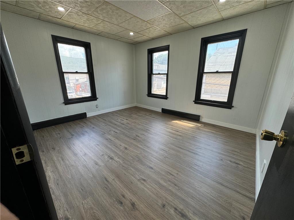 200 South Coal Street Shamokin, PA 17872 - Photo 13 of 18 Gleaming wood-look floors pair with classic paneled walls and dark-trimmed windows in this versatile room.