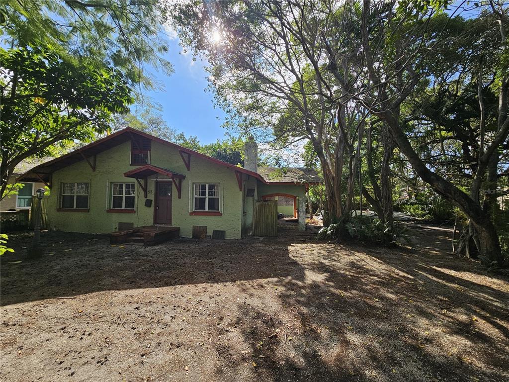 58 Northeast 48th Street Miami, FL 33137 - Photo 5 of 9 a front view of a house with a yard