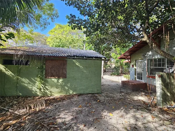 a view of a small house with a garden