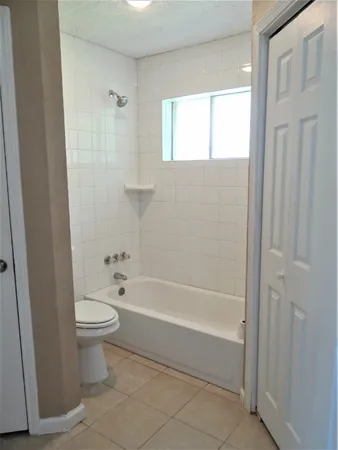 a bathroom with a toilet and a bathtub