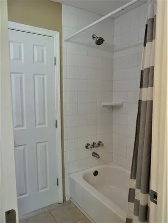 a bathroom with a tub and shower