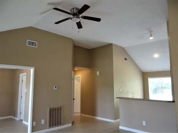 a view of a livingroom with a ceiling fan and a window
