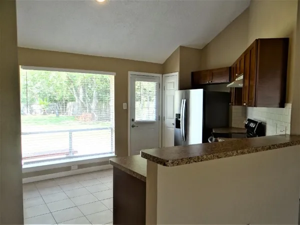a kitchen with a refrigerator and a sink