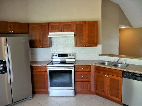 a kitchen with a sink and a refrigerator