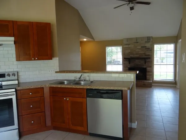 a kitchen with a sink and a stove top oven