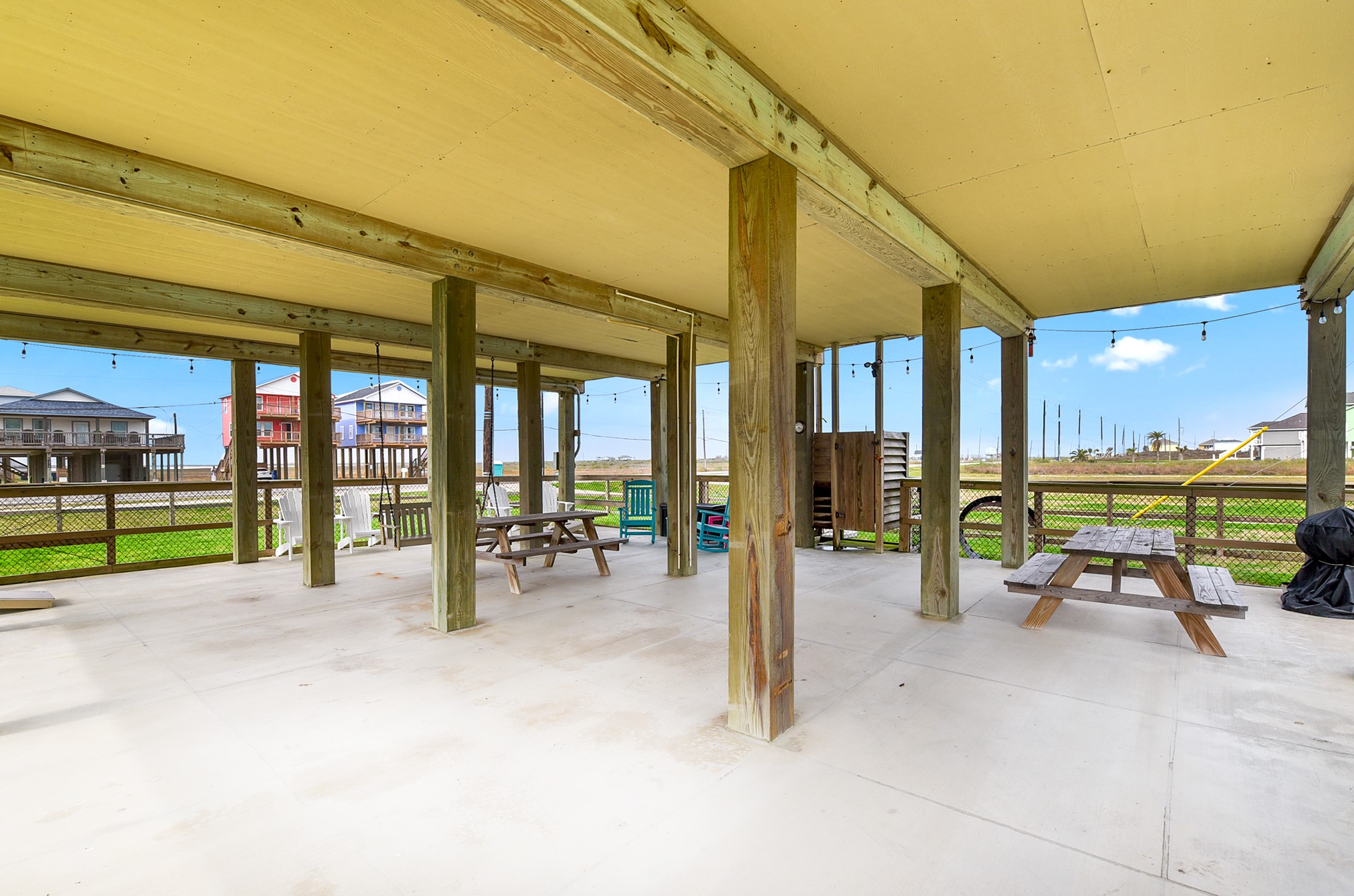 126 Nesmith Place Surfside Beach, TX 77541 - Photo 11 of 48 a view of a patio with a table and chairs