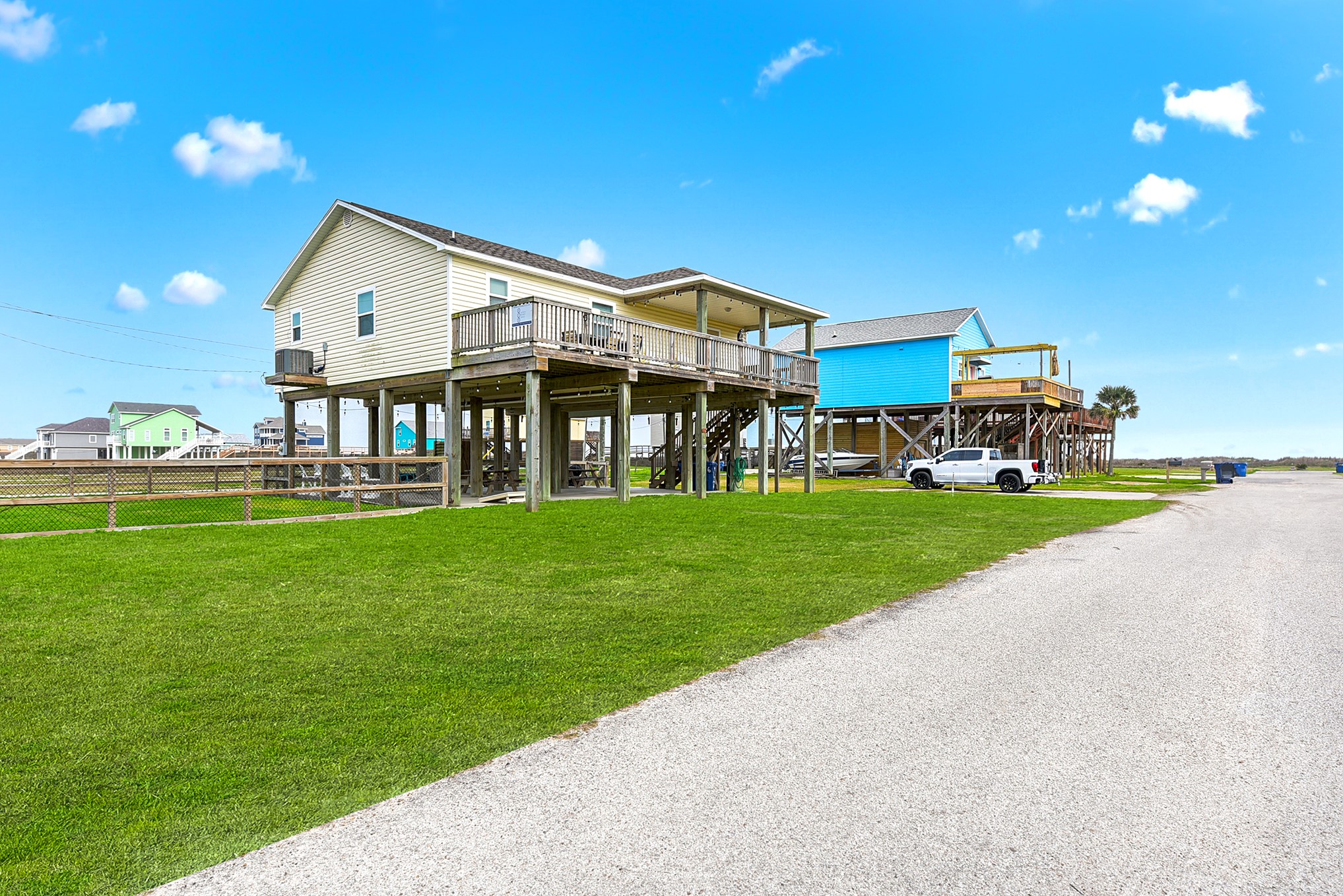 126 Nesmith Place Surfside Beach, TX 77541 - Photo 3 of 48 a front view of a house with a yard table and chairs