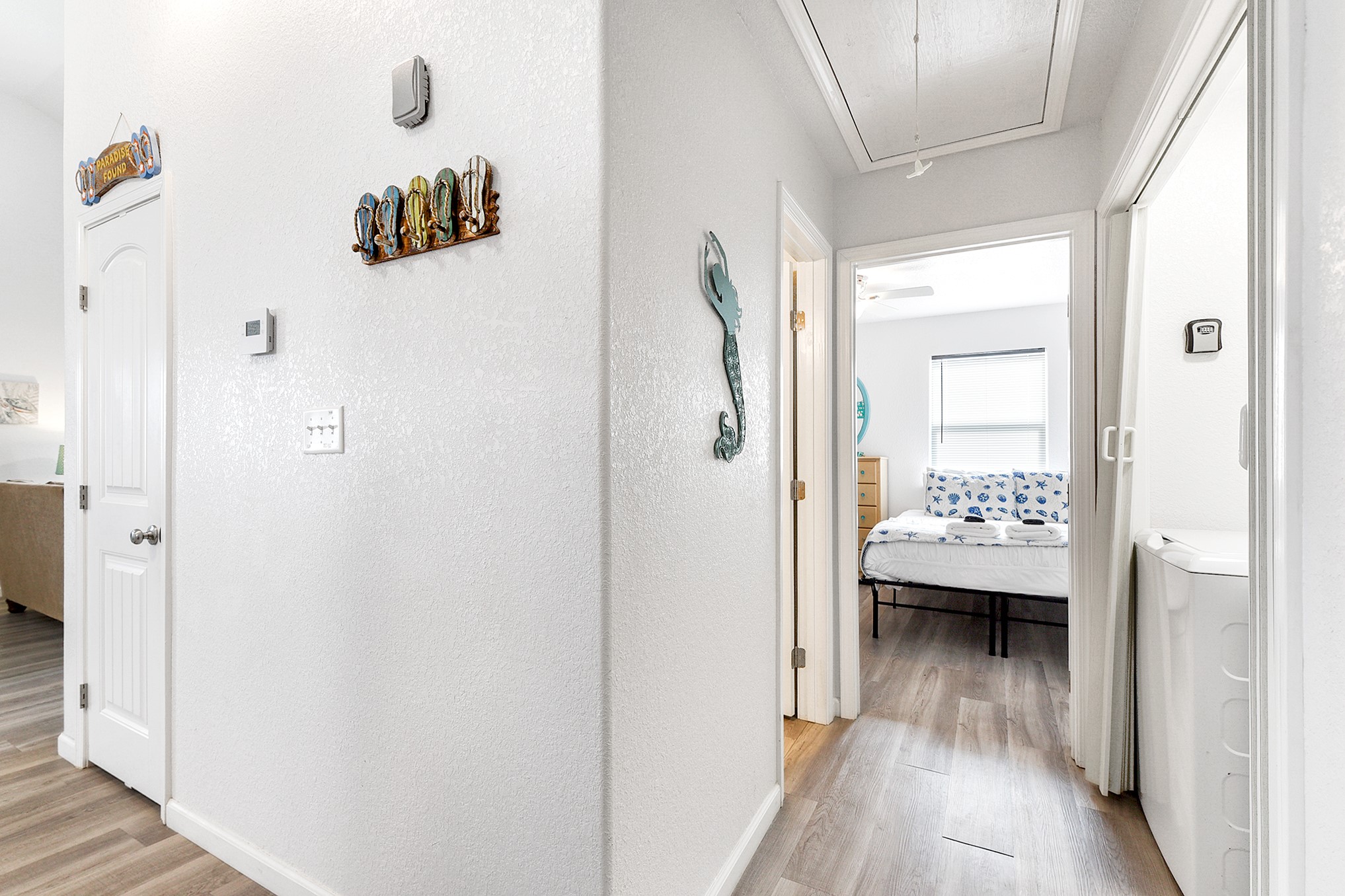 126 Nesmith Place Surfside Beach, TX 77541 - Photo 30 of 48 a view of a hallway with wooden floor and a bathroom
