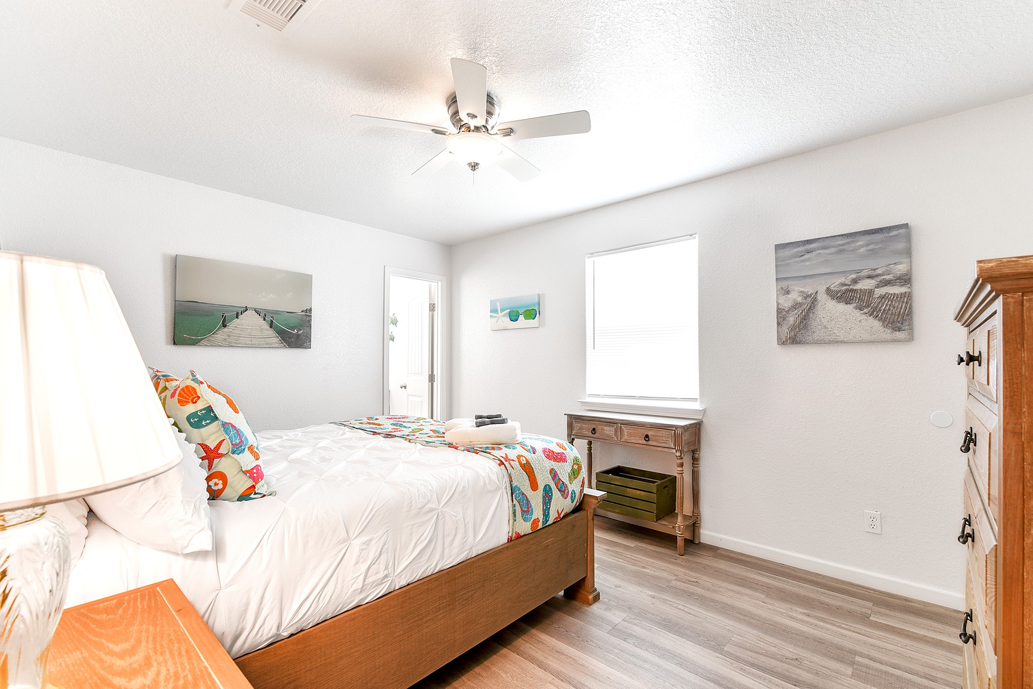 126 Nesmith Place Surfside Beach, TX 77541 - Photo 31 of 48 a bedroom with a bed and a chandelier