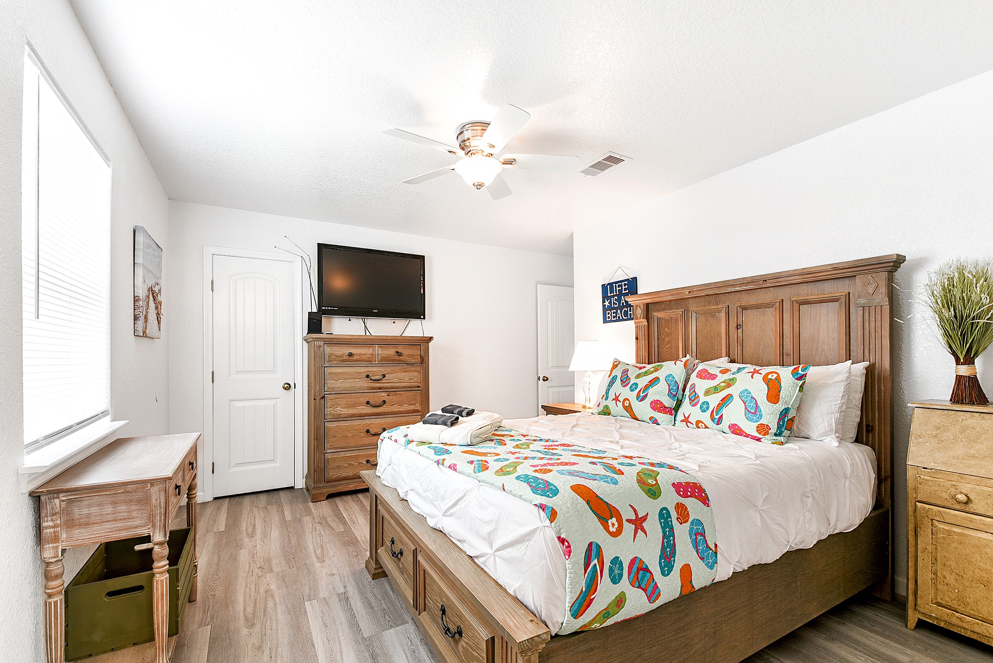 126 Nesmith Place Surfside Beach, TX 77541 - Photo 32 of 48 a bedroom with a bed a flat tv screen and a dresser