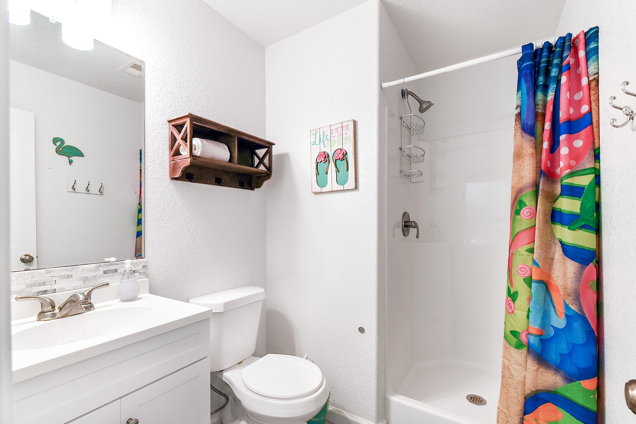 126 Nesmith Place Surfside Beach, TX 77541 - Photo 34 of 48 a bathroom with a sink a toilet and shower curtain