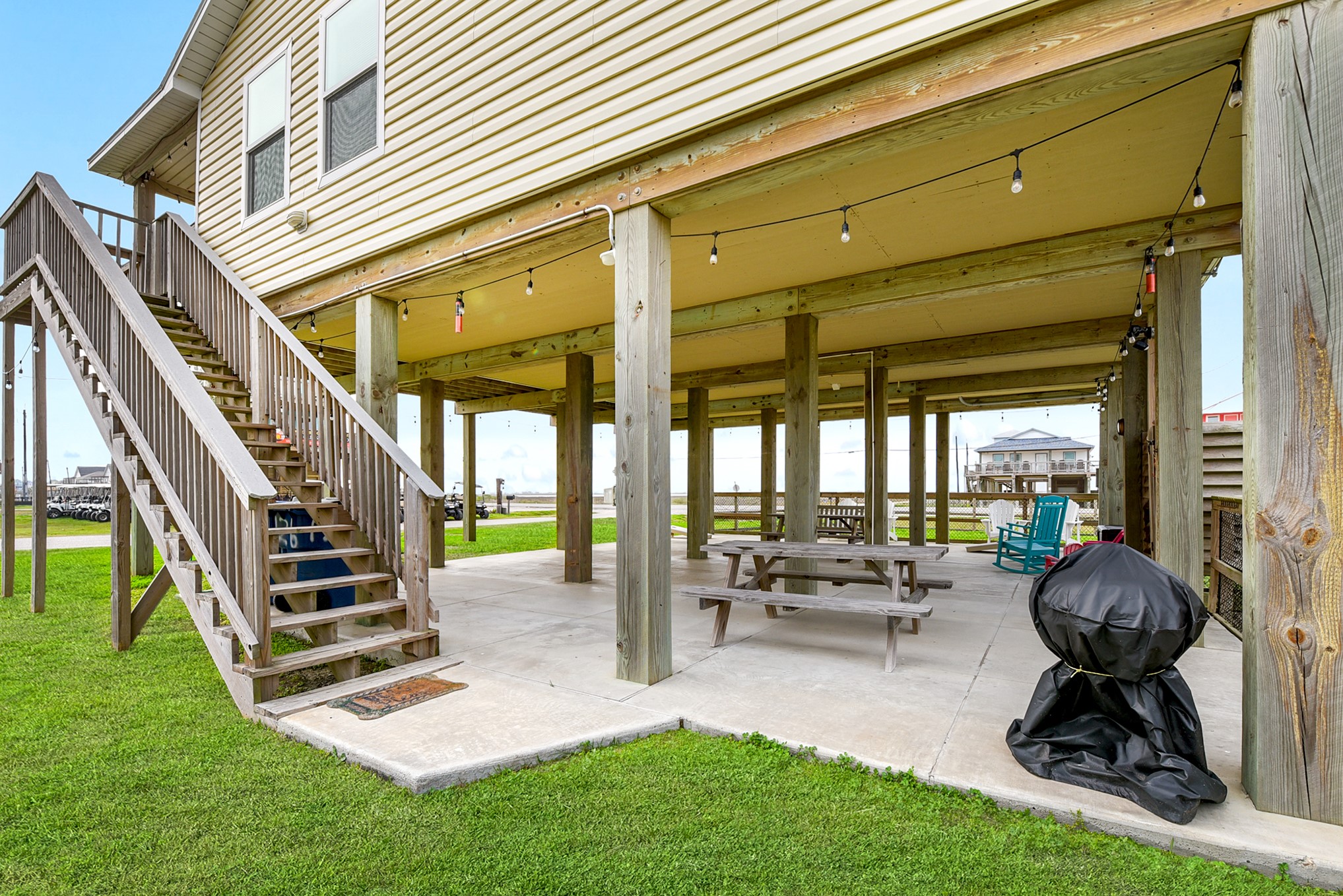 126 Nesmith Place Surfside Beach, TX 77541 - Photo 10 of 48 a view of a chairs and tables in the patio