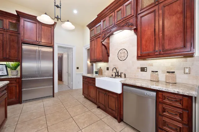 a kitchen with granite countertop a sink and cabinets