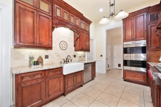 a kitchen with stainless steel appliances granite countertop a refrigerator and a stove top oven
