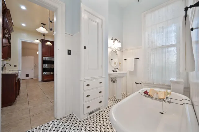 a view of a patio with table and chairs potted plants and wooden fence