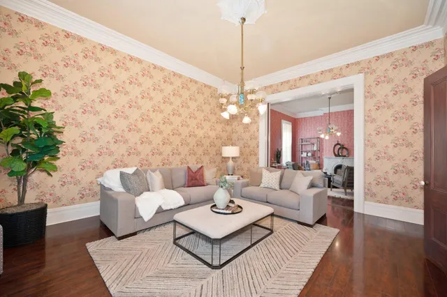 a living room with furniture and a chandelier