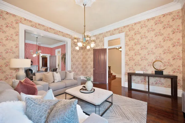 a living room with furniture and a chandelier