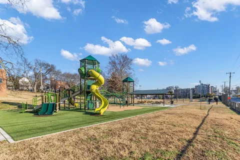 a childrens park with lots of swings and slides