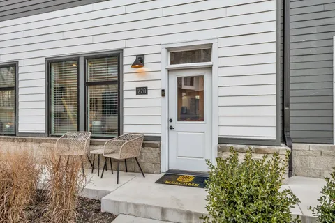 a view of a chair and fire pit in the backyard